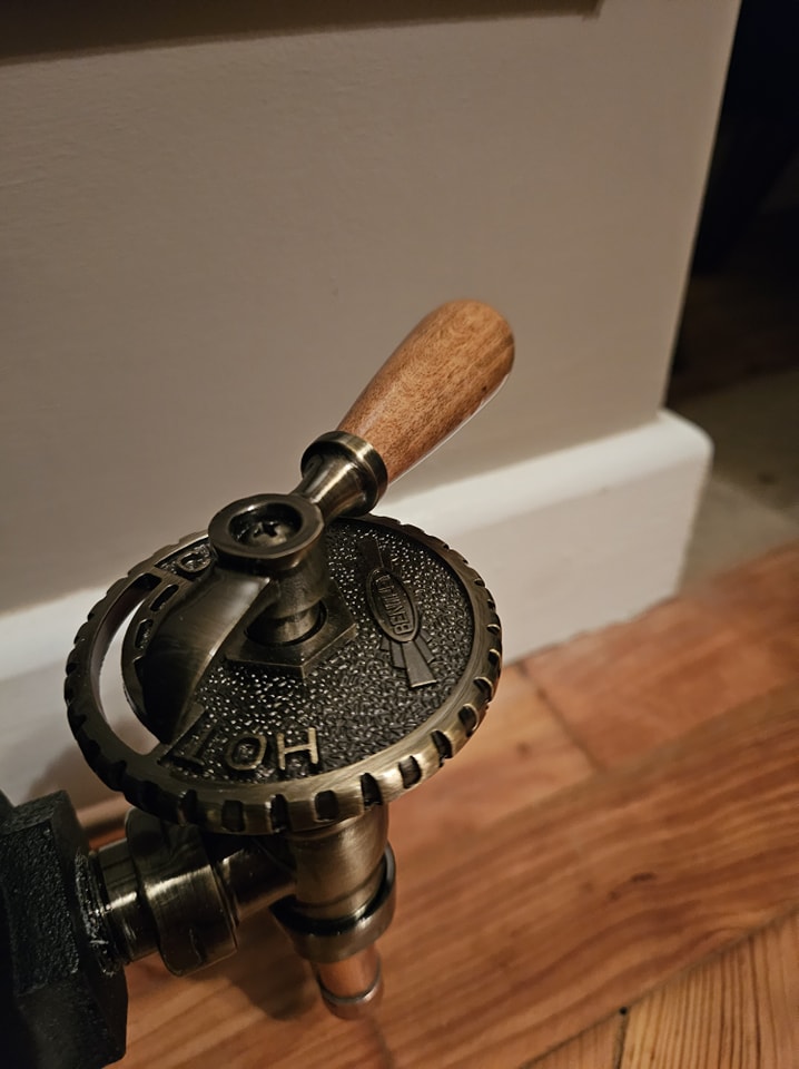 Close-up of an old-style radiator valve with a wooden handle